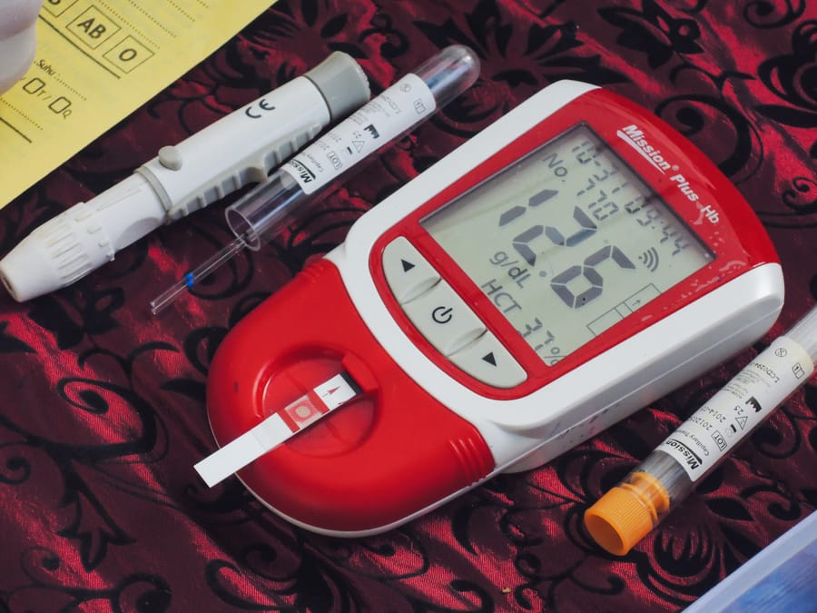 Blood glucose meter with test strips and lancets