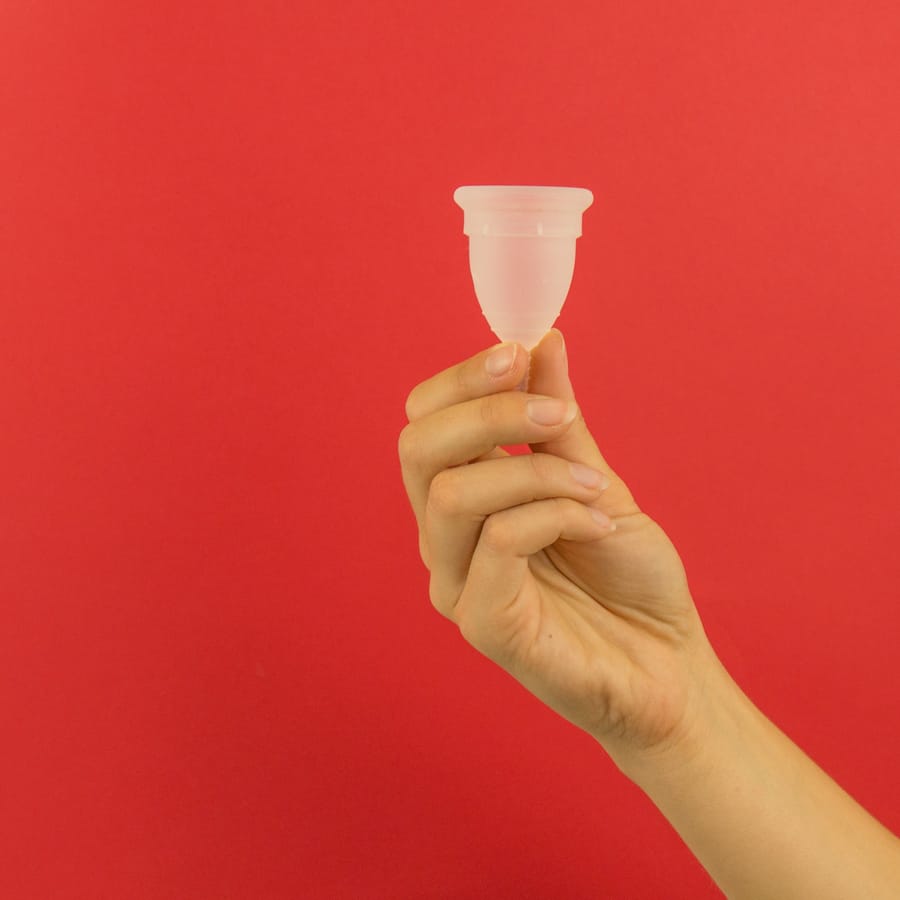 Hand holding a menstrual cup