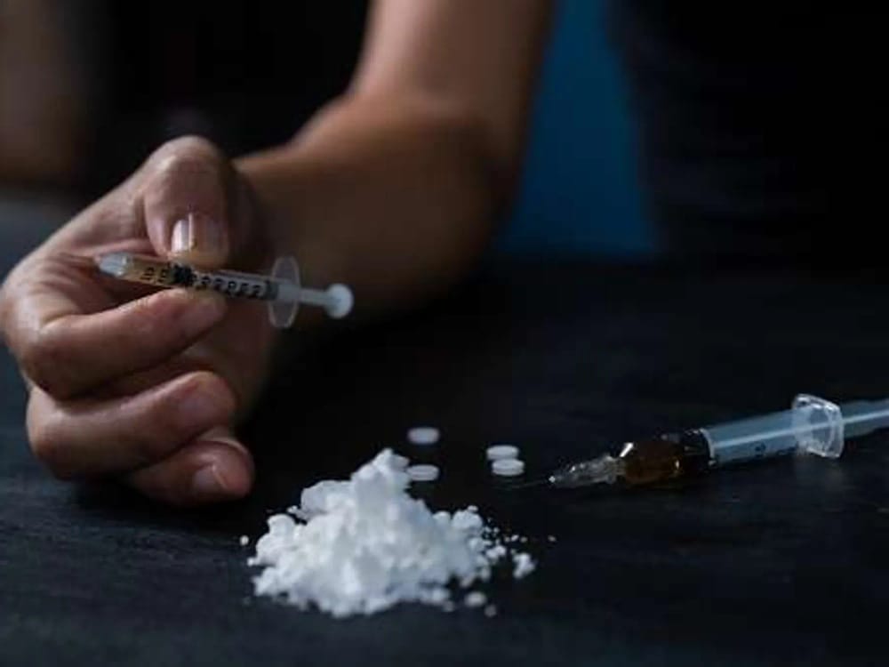 Syringe and powder on a table