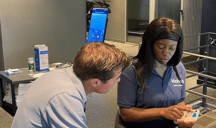 Researchers testing smartphone oxygen saturation measurement with a participant